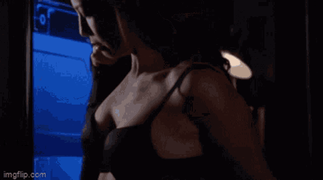 a woman in a black bra is standing in front of a monitor with imgflip.com at the bottom