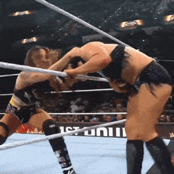 two women are wrestling in a ring with a sign that says ' 1st univ ' on it