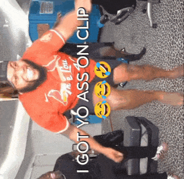 a man wearing a red shirt that says " i got yo ass on clip "