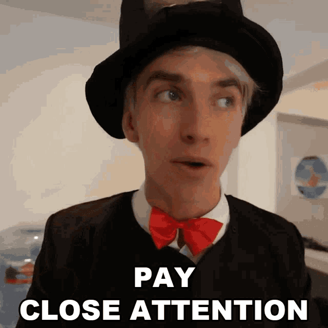 a man wearing a top hat and a bow tie says " pay close attention "