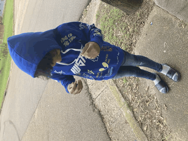 a boy wearing a blue hoodie that says hustle on it