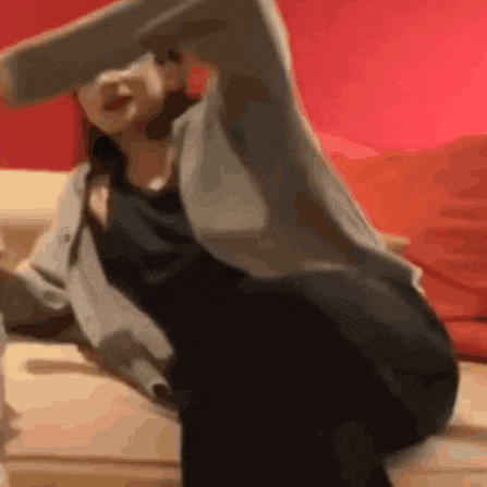 a woman is sitting on a couch with her legs crossed and her arms outstretched .