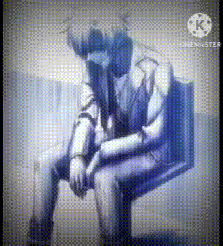 a man is sitting on a chair with his head down .