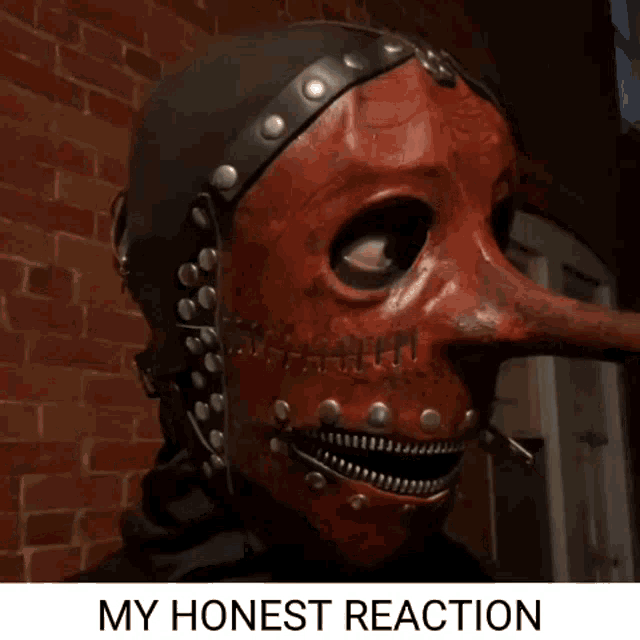 a red mask with a long nose and the words my honest reaction underneath it