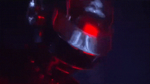 a close up of a person 's face with red lights coming out of it .
