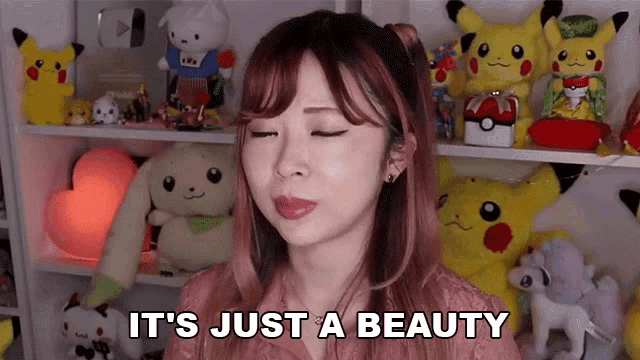 a woman says it 's just a beauty in front of a shelf full of stuffed animals