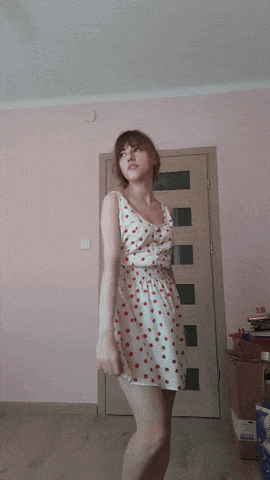 a woman in a white dress with red polka dots