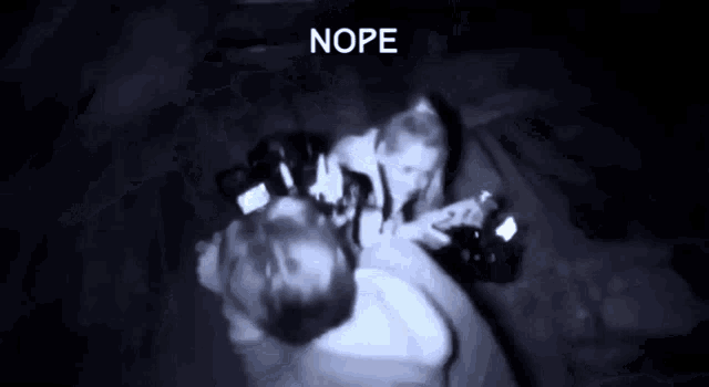 a blurry picture of a man and a woman with the word nope written above them
