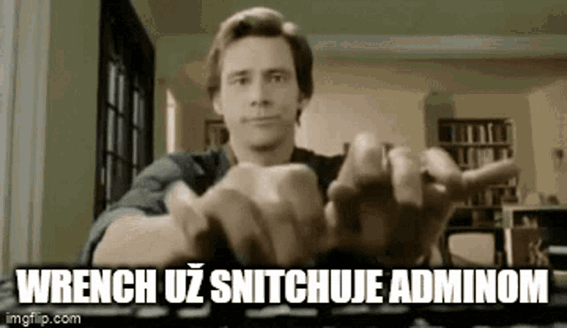 a man is typing on a keyboard with the words wrench uz snitchuje adminom above him .