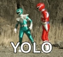 a green power ranger and a red power ranger are standing next to each other in a field .