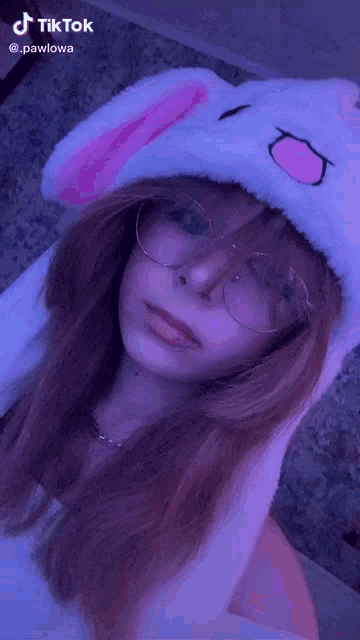a girl is wearing a bunny hat and glasses