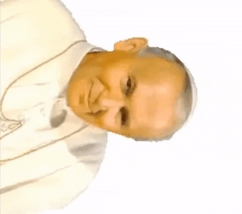 a man wearing a white robe and a cross around his neck