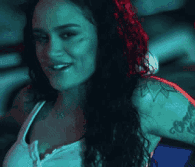 a woman with a tattoo on her shoulder that says ' i love you '