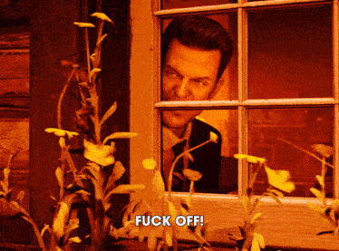 a man is peeking out of a window with the words fuck off written below him