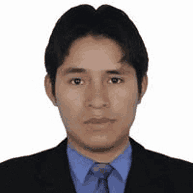 a man wearing a suit and tie is looking at the camera .