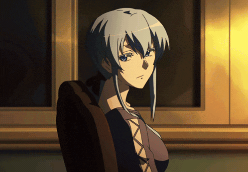 a woman with gray hair is sitting in a chair