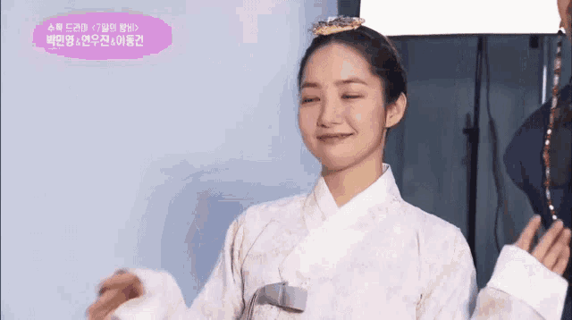 a woman in a traditional korean dress with a crown on her head