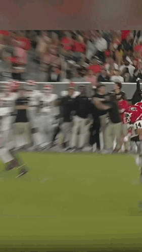 a man wearing a headset is running on a field