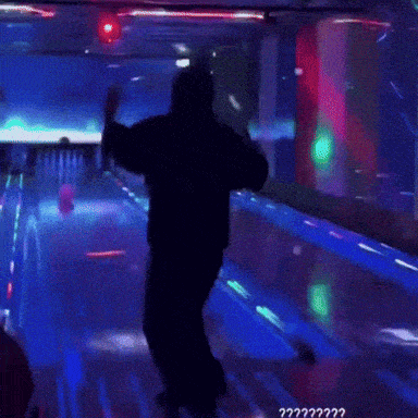 a woman covering her face in a bowling alley with the words " ?? " on the bottom right