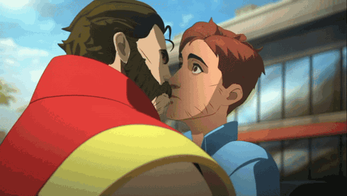 a man with a beard kisses another man on the cheek