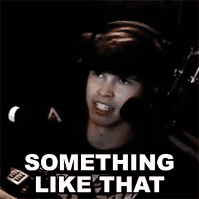 a man wearing headphones is talking into a microphone and says something like that .