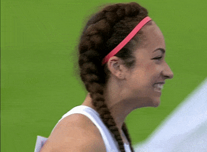 a woman with braids wearing a pink headband is smiling