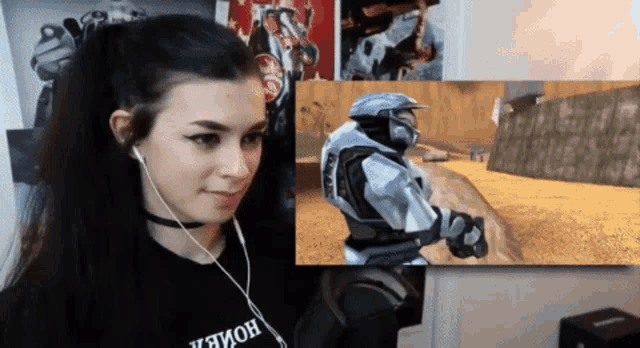 a woman wearing headphones looks at a video game screen