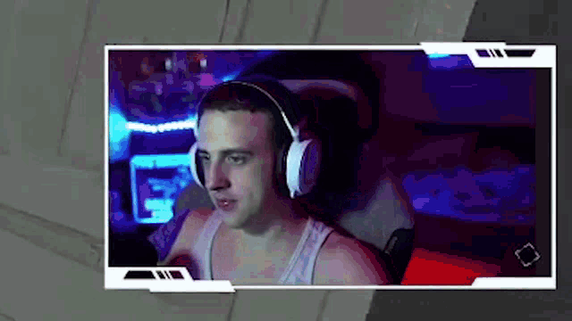 a man wearing headphones is sitting in a chair in front of a computer .