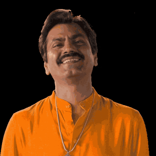 a man with a mustache wearing an orange shirt