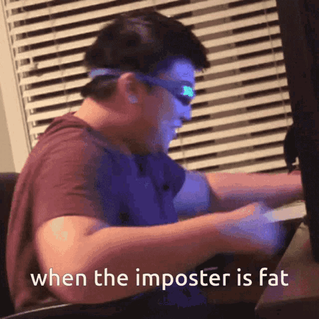 a man sitting at a desk with the words when the imposter is fat written below him