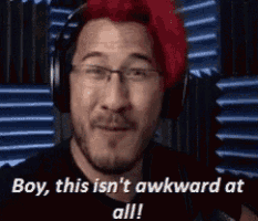 a man with red hair is wearing headphones and says boy this is n't awkward at all .