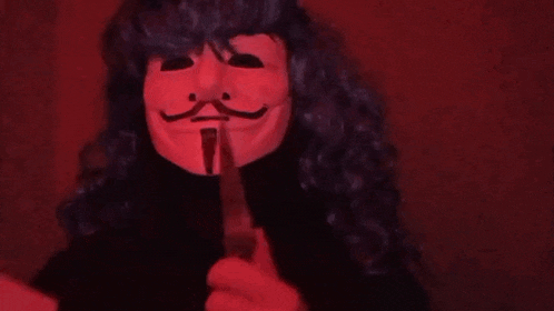 a woman wearing a mask is holding a piece of paper in her hand .