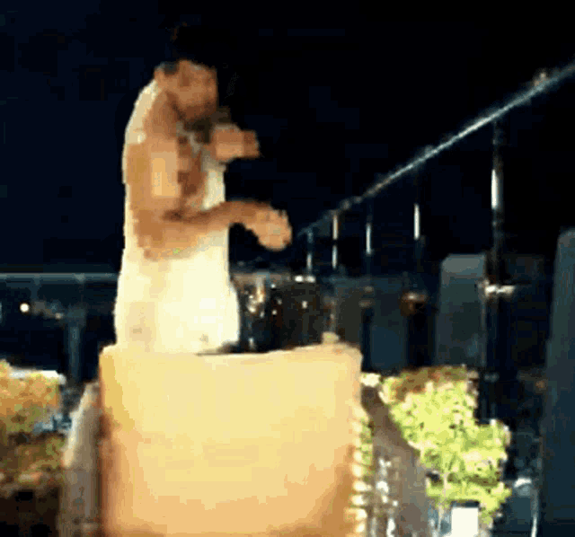 a bride and groom are kissing on top of a candle