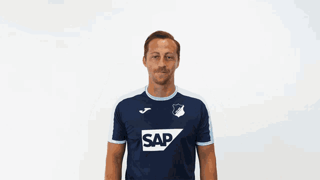 a man is wearing a blue shirt with the word sap on it