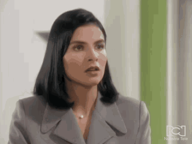 a woman 's face is shown in front of a screen that says nuestra tele
