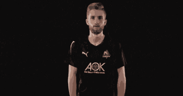 a man wearing a black shirt with ac on it
