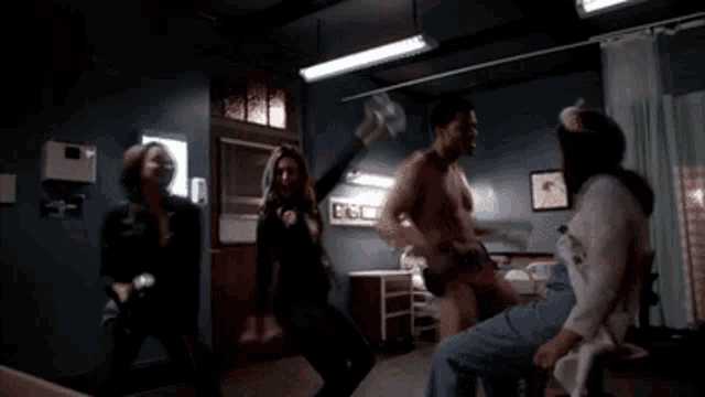 a group of people are dancing in a room with a sign that says ' ecg ' on it