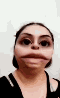 a woman is making a funny face with her mouth wide open and her eyes closed .