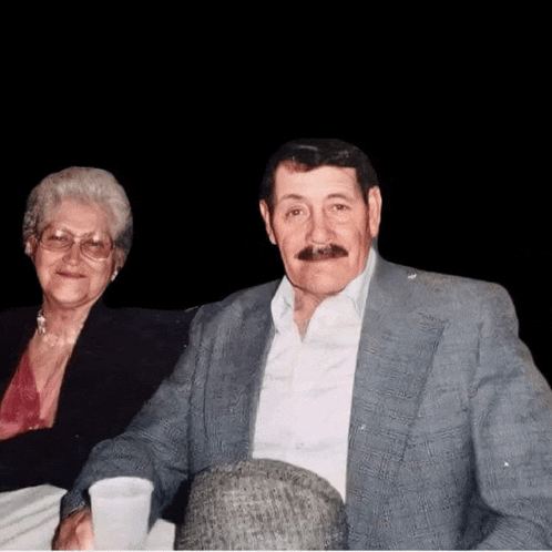 a man and a woman are sitting at a table .