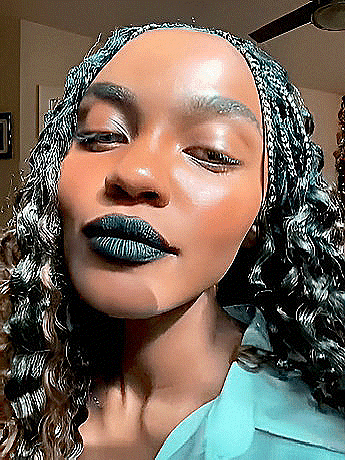 a close up of a woman 's face with her eyes closed and black lipstick on her lips .