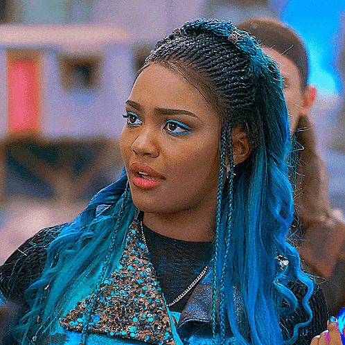 a woman with blue hair is wearing a black top