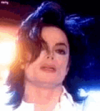 a close up of a person 's face with a blue background