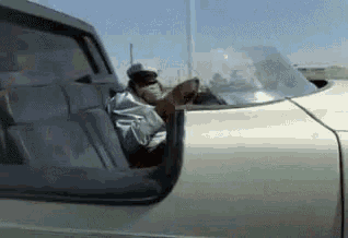 a person is sitting in the back seat of a car .