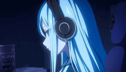 a girl with long blue hair wearing headphones looks at a computer monitor