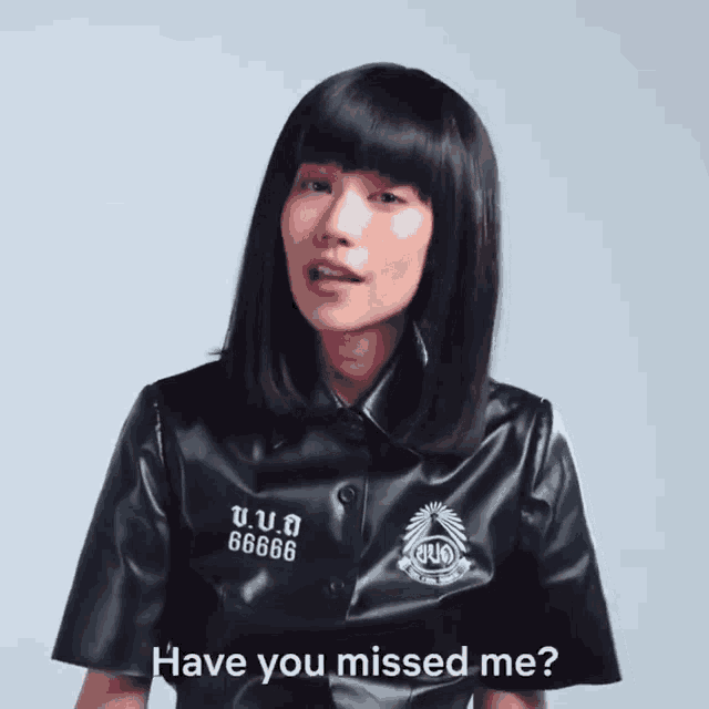 a woman wearing a black shirt with the number 66666 on it says have you missed me