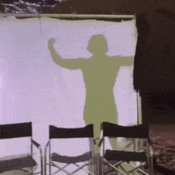 a shadow of a man is projected on a white screen