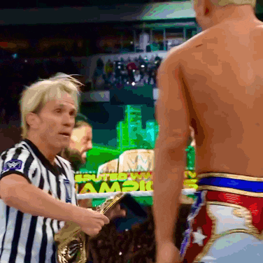 a referee is talking to a wrestler in front of a sign that says " sputed "