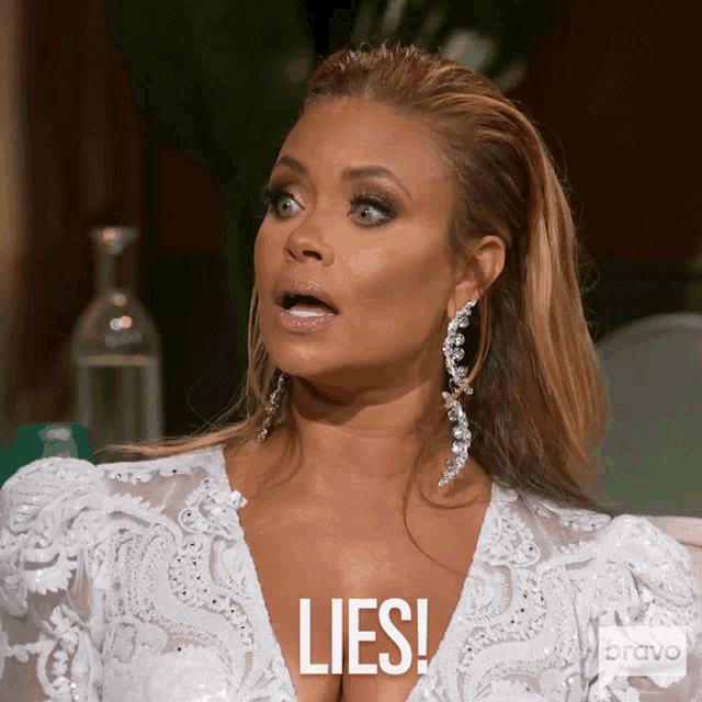 a woman in a white dress has the word lies on her chest