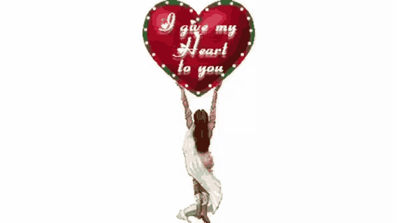 a woman is holding a large heart that says i give my heart to you