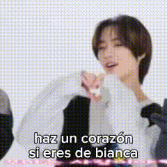 a man is holding a balloon and says haz un corazon si eres de bianca .